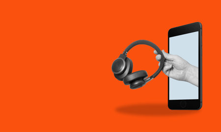 Art collage digital pop contemporary art.Man hand holding smartphone with the earpiece. Listening to podcasts, and music. Asmr sound therapy, webinar, worship, minimal digital music.DJ headphones.の写真素材