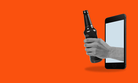 Art collage holding a bottle of beer from a phone on a red background with space for advertising. The concept of social media, influence, popularity, modern lifestyle, and advertisingの写真素材