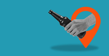 Art collage holding a bottle of beer from the navigation sign on a blue background with space for advertising. The concept of social media, influence, popularity, modern lifestyle, and advertisingの写真素材