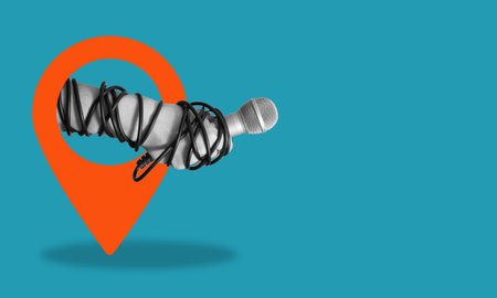 Modern art collage, the hand with a microphone on the navigation icon, on a blue background Concept of an interview or news with room for advertising.の写真素材