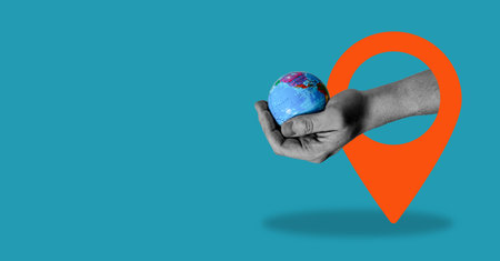 A digital collage of contemporary art. Hand-holding globe with navigation icon, blue background with space for text.の写真素材