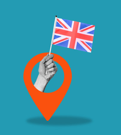 The art collage is the hand with the UK flag and the Navigation icon on a blue background. The concept of the enlightened country of Great Britain.の写真素材