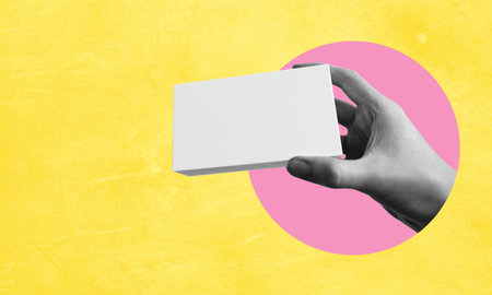 Human hand with white geometric speech bubble on yellow abstract background. Copy space for advertising, text, and design. Collage in the style of minimalism. Art, surrealism, human rightsの写真素材