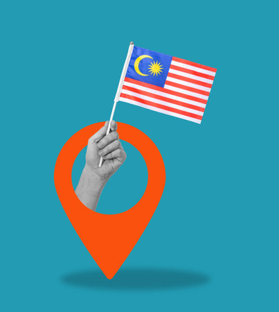 Art collage, Hand with Malaysian flag on blue background with navigation icon. The concept of tourism and travel.の写真素材