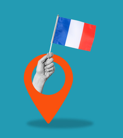 Art collage, Hand with the flag of France and a navigation icon on a blue background. The concept of travel and tourism.の写真素材