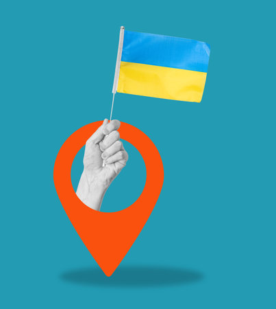 Art collage, hand with the flag of Ukraine on a blue background with a navigation sign. Concept of navigation and placement.の写真素材