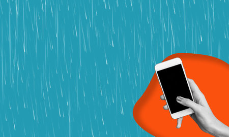 Cell phone with black screen in woman's hand, isolated on blue background. Blank space for text....