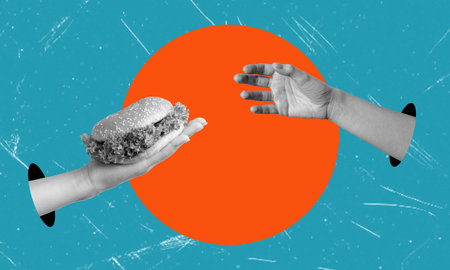 Hand burger passes on blue background with orange circle. Artistic collage. Unhealthy food delivery concept.の写真素材