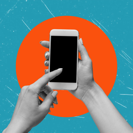 Cell phone with black screen in female hands, isolated on orange and blue background. Smartphone mockup. Modern art. Modern designの写真素材