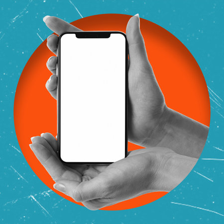 Cell phone with white screen in female hands, isolated on blue background. Blank space for copying. Smartphone mockup. Modern art. Modern designの写真素材