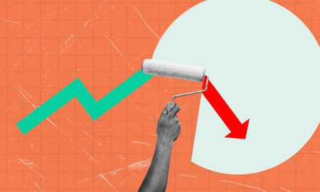 A hand holding a paint roller is painting over an upward green arrow with a red downward arrow, signifying a change in direction. The background is a textured orange surface with a white circle in the upper right corner.の写真素材