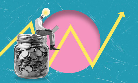 A person with a lightbulb for a head studies financial trends on a laptop, sitting on a jar filled with coins, symbolizing innovation and economic growth.の写真素材