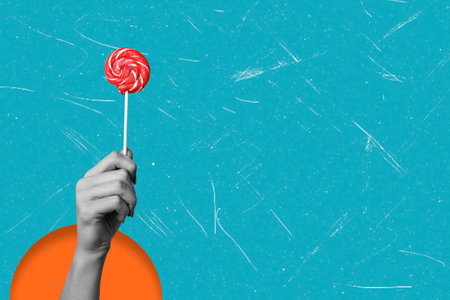 Modern art collage depicting a hand with a lollipop on a blue background with copy space. The concept of a tasty lollipop.の写真素材