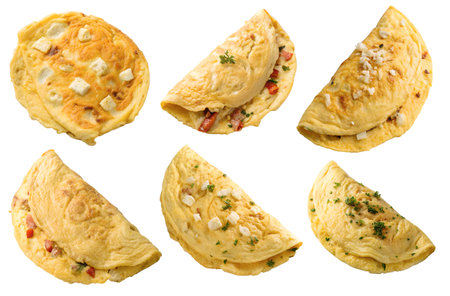 Six omelets are displayed with different toppings and fillings, including cheese, peppers, and herbs, presenting a variety of breakfast options against a white background.の写真素材