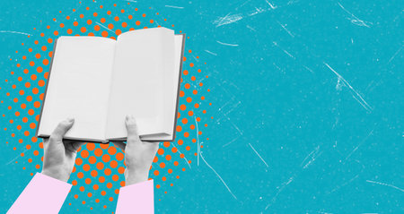 Open book in hand on a blue background with copy space. The concept of education and learning.の写真素材