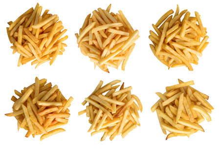 Various piles of golden fries are neatly arranged on a white background, emphasizing their crispy...