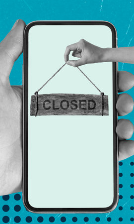 A hand reaches into a smartphone screen to hold a wooden closed sign. The background features a vibrant blue design, showing a blend of technology and closure.の写真素材