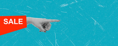 A hand with manicured nails points towards a bold sale message on a vibrant blue surface. The scene highlights an ongoing promotional offer designed to attract attention.の写真素材