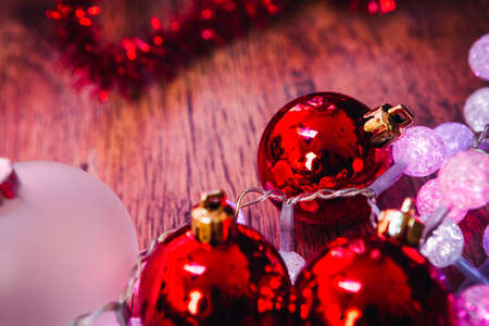red white christmas balls and garland   on a wooden backgroundの写真素材
