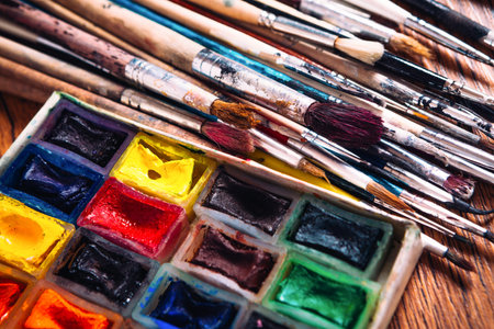 Many brushes and paint for painting on wooden  backgroundの写真素材