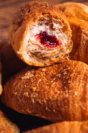 croissants with jam on a wooden  background
