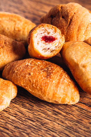 croissants with jam on a wooden  backgroundの写真素材