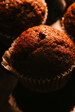 Chocolate muffins with nuts on dark  background, selective focusの写真素材