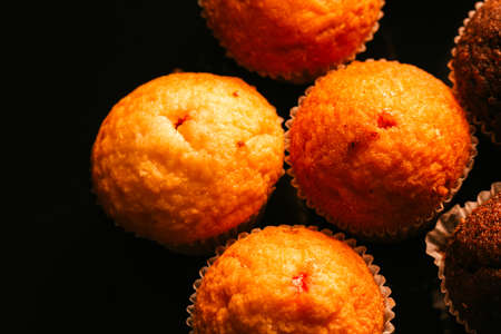 Chocolate muffins with nuts on dark  background, selective focusの写真素材