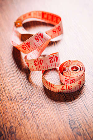 tailor tool for measurement of length on wooden  backgroundの写真素材