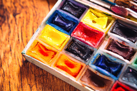 Many brushes and paint for painting on wooden  background