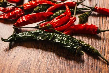 green pepper and Red peppers on  wooden tableの写真素材