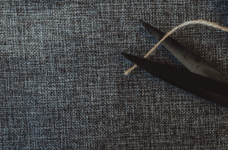 retro sewing tools: old scissors, bobbins of thread on gray fabric. Tailor's desk. manufacture of...