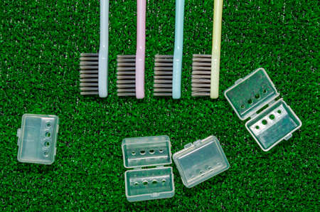 clean colorful toothbrushes on green grassの写真素材