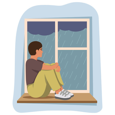 Sad boy sitting by window watching rain outside on gloomy day. Vector illustrationのイラスト素材