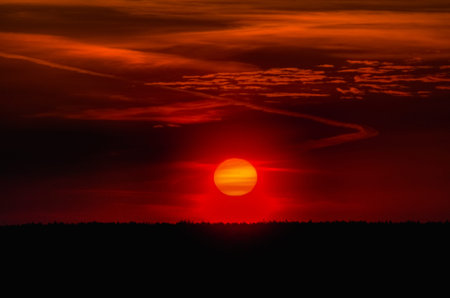 Big Sun Setting. Orange sky and dramatic sunbeams