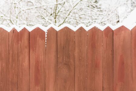 Old wooden fence in a snowの写真素材