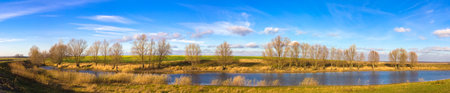 Autumn landscape of river and trees and bushes