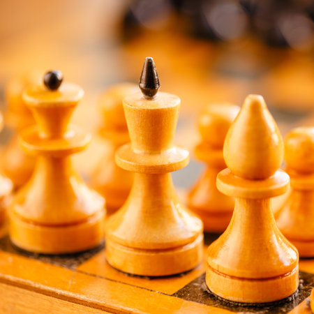 Chess standing on ancient wooden chessboard