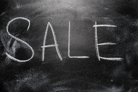 Handwritten message on a school chalkboard writing concept inscription, communication message, announcement Saleの写真素材