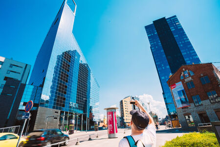 TALLINN, ESTONIA - JULY 26: Tourists Take Photos Of Blue Skyscrapers Of Glass And Concrete In Center Of The Modern Estonian Capital On July 26, 2014 In Tallinn, Estoniaのeditorial素材