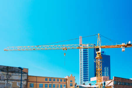Construction Crane On Background Of New Modern Skyscraper And Old Buildings Intended For Demolition In Estonian Capital Tallinn, Estonia.の写真素材