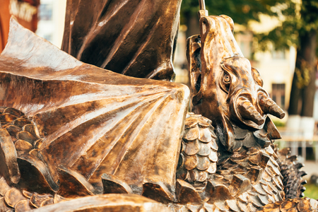Close Up Detail Of Statue Of Archangel Michael With Outstretched Wings, Thrusting Spear Into Dragon Before Red Catholic Church Of St. Simon And St. Helena On Independence Square In Minsk, Belarusの写真素材