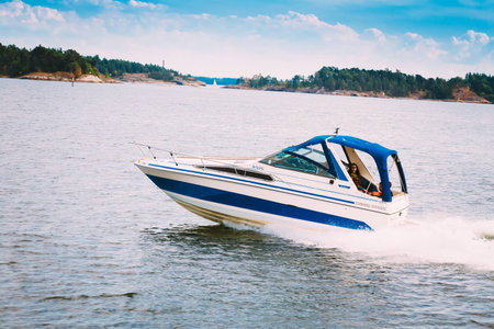 HELSINKI, FINLAND - JULY 27, 2014: Family on speedboat waving on Gulf Of Finlandのeditorial素材