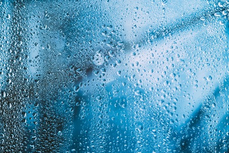 Water Drops Of Rain On Blue Glass Backgroundの写真素材