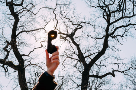 Real Solar Eclipse On March 20, 2015. Moon Covering Sun In Partial Eclipse. Female Hand Holding A...