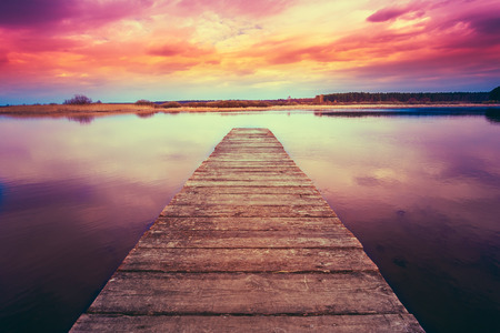 Old Wooden Pier. Calm River Nature Background. Toned Instant Filtered Photo Imageの写真素材