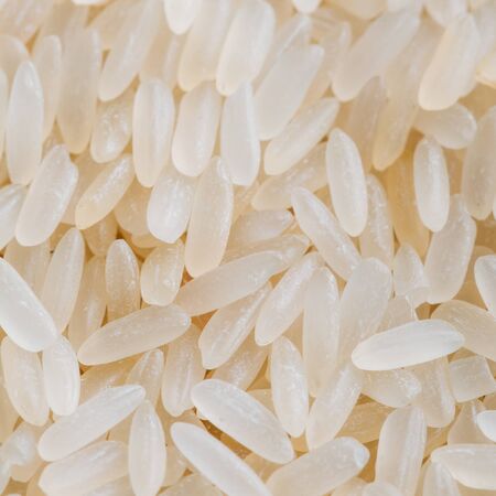 White Long Rice Background, Uncooked Raw Cereals, Macro Close up Detail Textureの写真素材