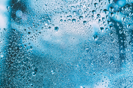Water Drops Of Rain On Blue Glass Background
