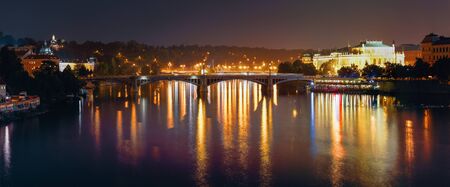 Night Panorama Of Prague, Czech Republic. Panoramic Night View Of Vltava River And Manes Bridgeの写真素材