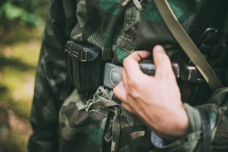 Unidentified re-enactor dressed as German soldier. German military decoration on the uniform of a German soldier.のeditorial素材